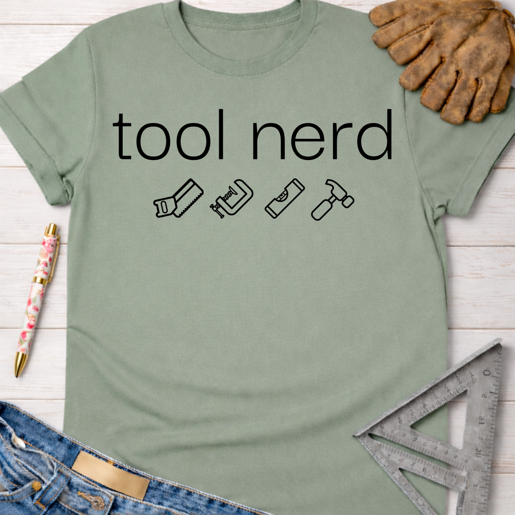 Women's funny woodworking graphic tee shirt for female woodworkers, makers, and DIY builders — Sawdust & Ponytails. Sage green cotton t-shirt with "tool nerd" text and tool icons.