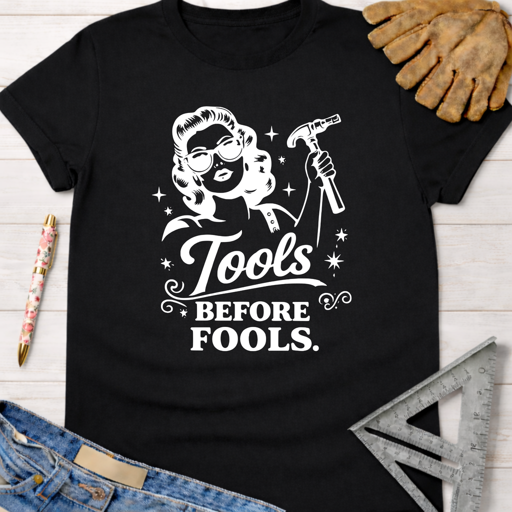 Black "Tools Before Fools" t-shirt with a retro woman holding a hammer. Women's funny woodworking graphic tee shirt for female woodworkers, makers, and DIY builders — Sawdust & Ponytails