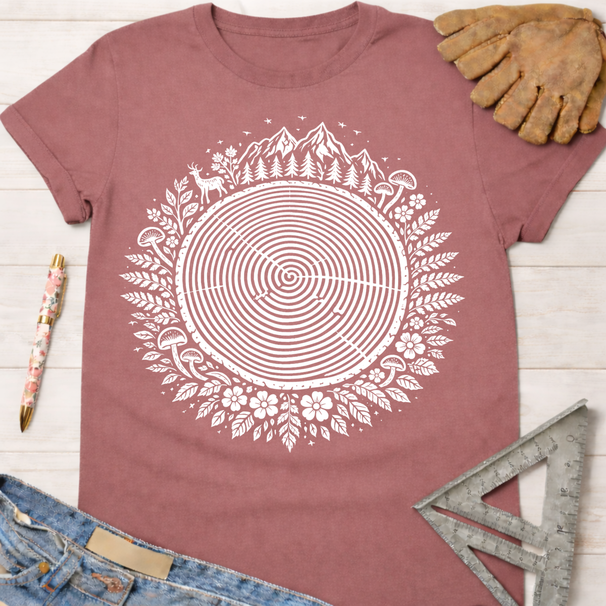 Women's funny woodworking graphic tee shirt for female woodworkers, makers, and DIY builders — Sawdust & Ponytails. Mauve t-shirt with white tree ring and nature graphic.