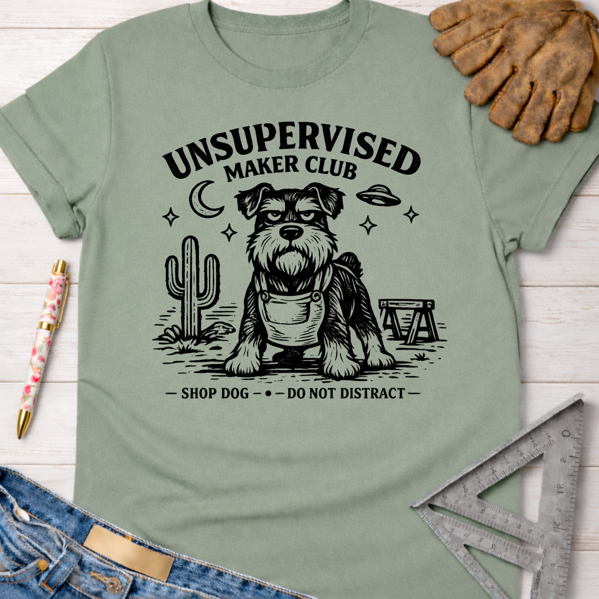 Women's funny woodworking graphic tee shirt for female woodworkers, makers, and DIY builders — Sawdust & Ponytails. Sage green cotton t-shirt with black "Unsupervised Maker Club" schnauzer graphic.