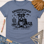 Women's funny woodworking graphic tee shirt for female woodworkers, makers, and DIY builders — Sawdust & Ponytails. Blue cotton tee with "Unsupervised Maker Club" graphic featuring a serious Schnauzer dog.