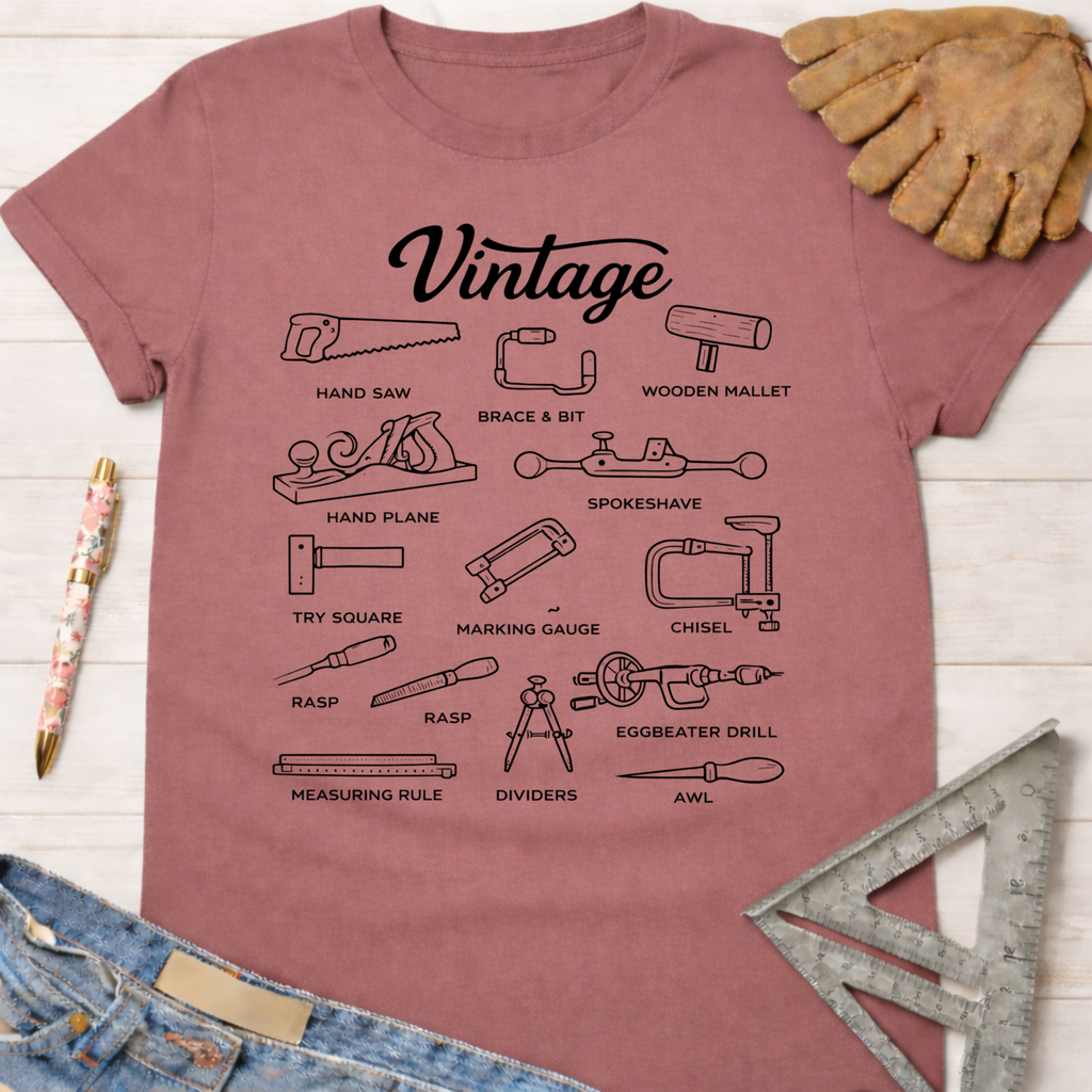 Women's funny woodworking graphic tee shirt for female woodworkers, makers, and DIY builders — Sawdust & Ponytails. Mauve cotton tee with black "Vintage" text and illustrations of classic woodworking tools.