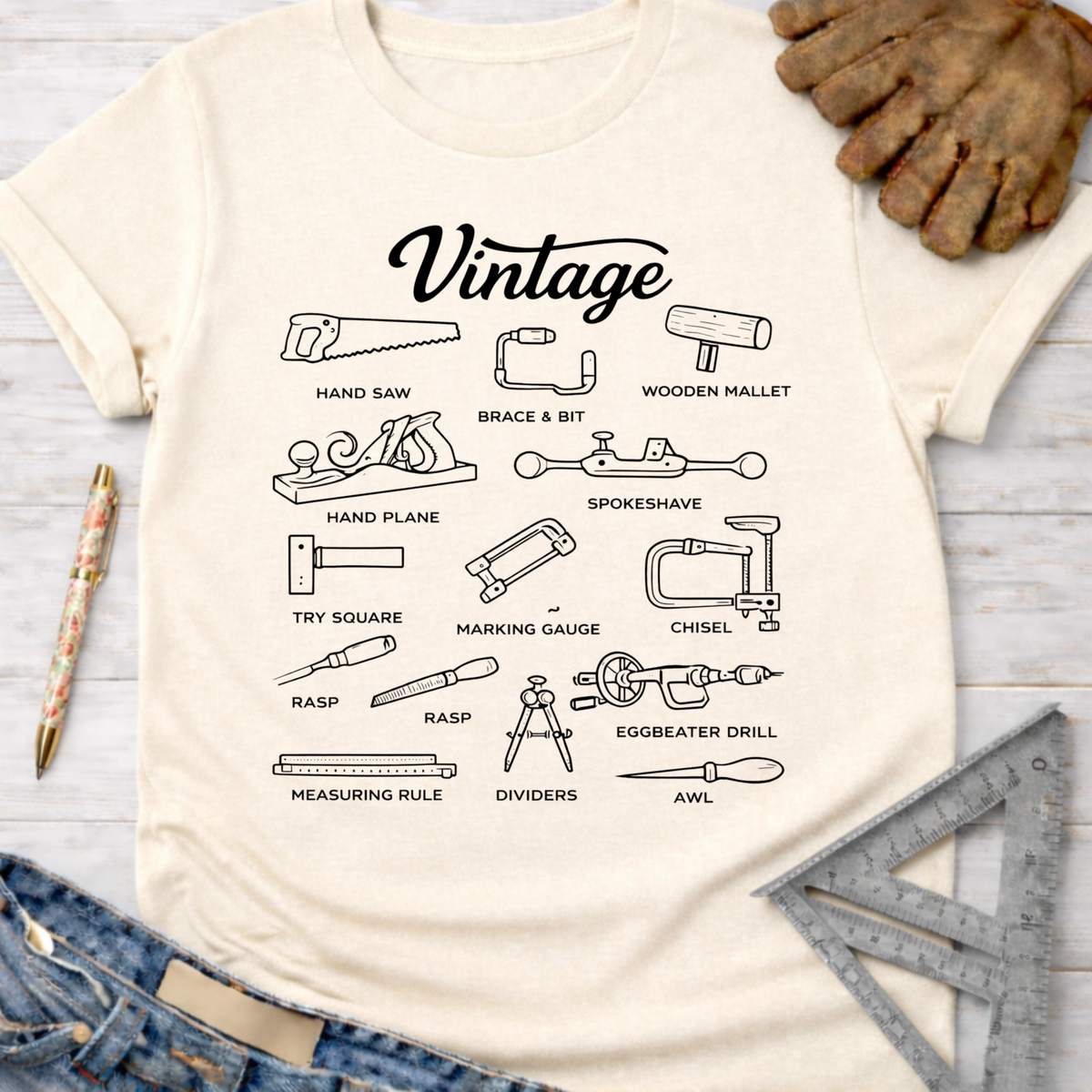 Women's funny woodworking graphic tee shirt for female woodworkers, makers, and DIY builders — Sawdust & Ponytails. Cream t-shirt with black line art of vintage tools.