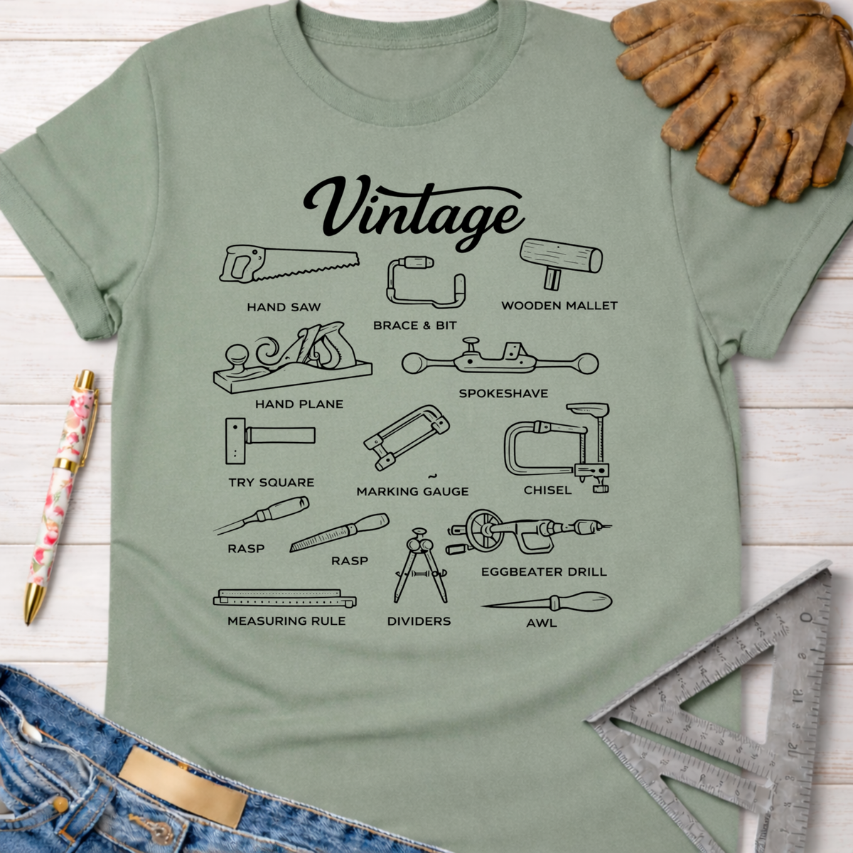 Women's funny woodworking graphic tee shirt for female woodworkers, makers, and DIY builders — Sawdust & Ponytails. Sage green cotton tee with black "Vintage" text and illustrations of classic hand tools.
