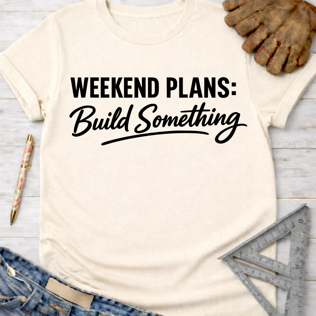Cream "Weekend Plans: Build Something" graphic tee with work gloves, jeans, pen, and ruler.