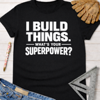 Black cotton "I Build Things. What's Your Superpower?" graphic tee with work gloves, jeans, and a ruler. Women's funny woodworking graphic tee shirt for female woodworkers, makers, and DIY builders — Sawdust & Ponytails