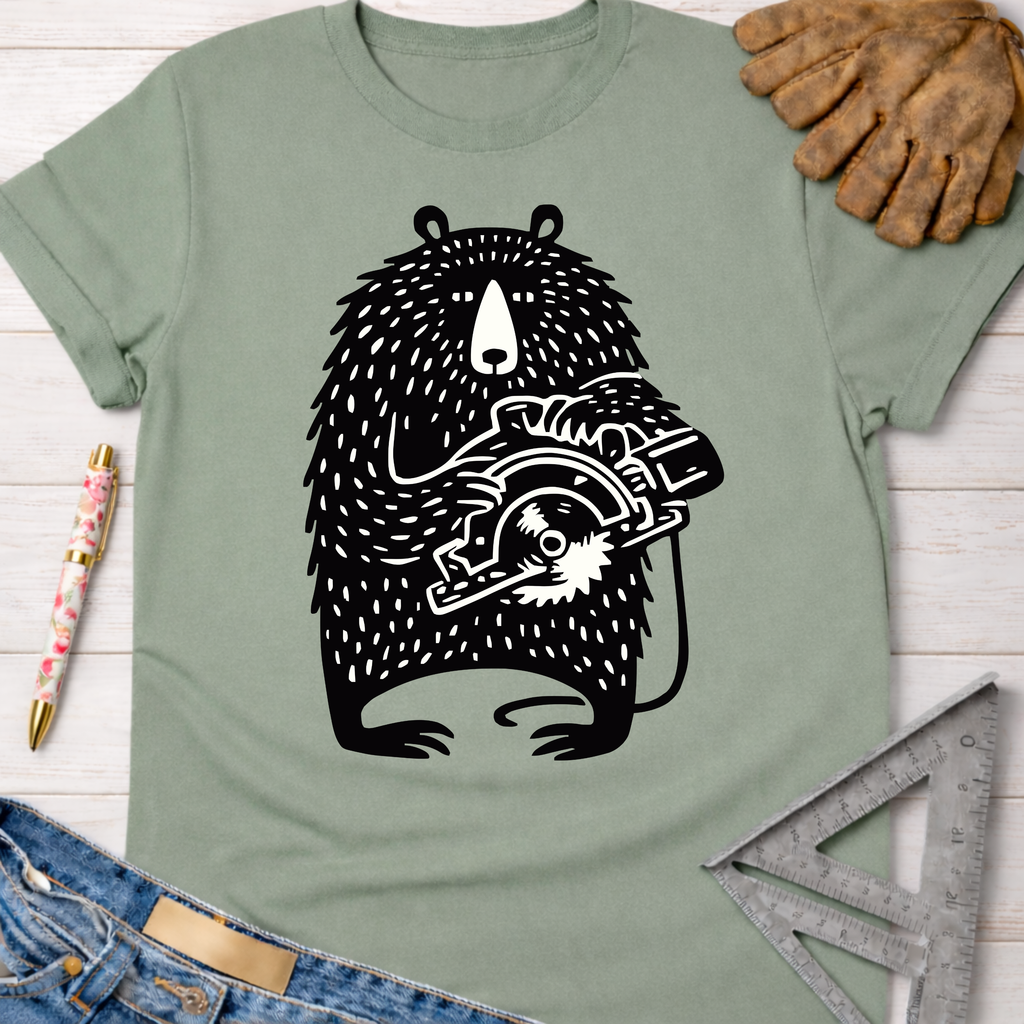 Sage green women's funny woodworking graphic tee with a black bear holding a circular saw. Women's funny woodworking graphic tee shirt for female woodworkers, makers, and DIY builders — Sawdust & Ponytails