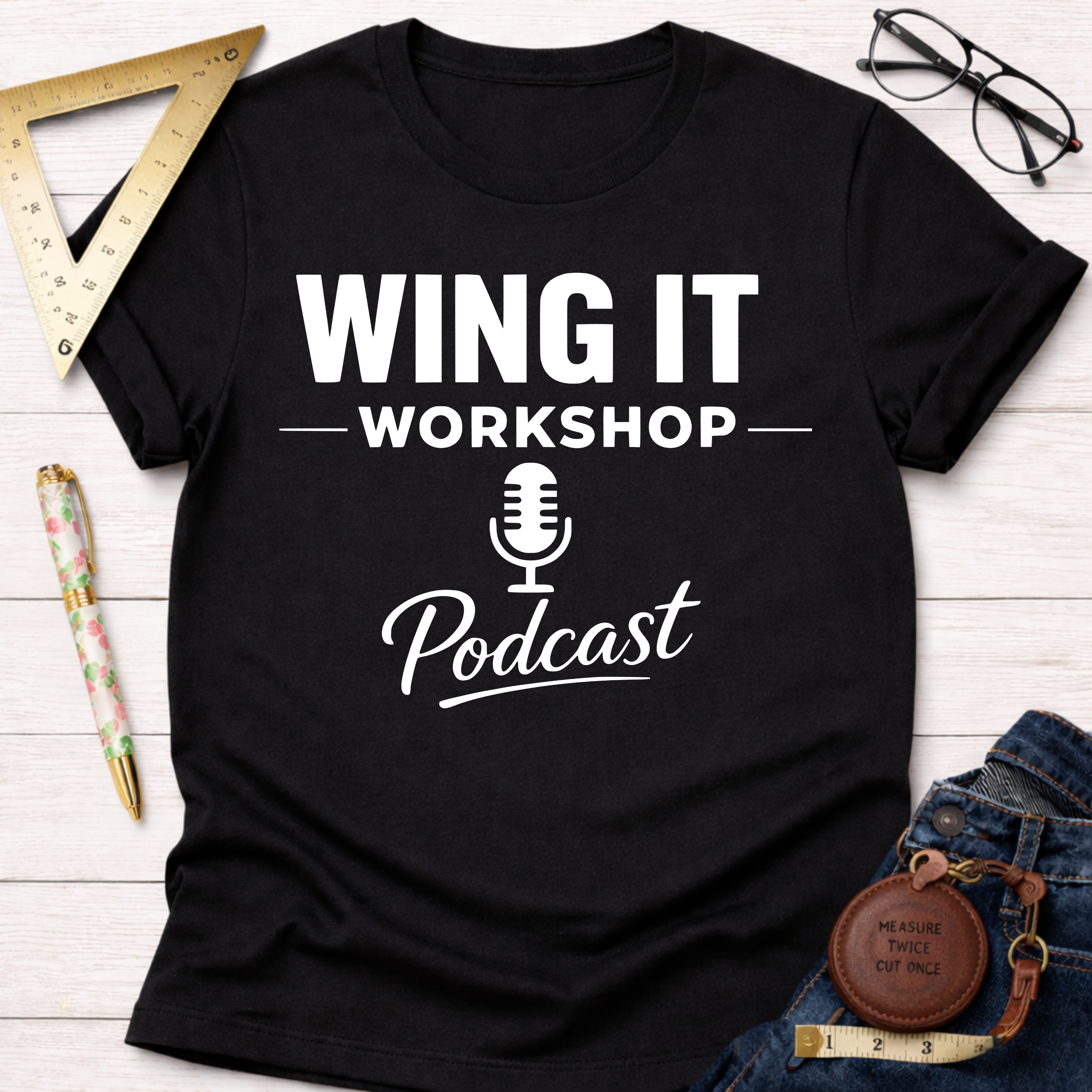 Black cotton "Wing It Workshop Podcast" t-shirt with white text, microphone graphic, and short sleeves.