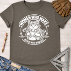 Women's funny woodworking graphic tee shirt for female woodworkers, makers, and DIY builders — Sawdust & Ponytails. Dark gray cotton tee with white graphic of a cat in goggles and overalls holding tools, "Women Who Make. Built Not Bought." text.