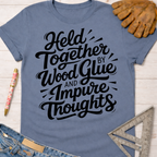 Women's funny woodworking graphic tee shirt for female woodworkers, makers, and DIY builders — Sawdust & Ponytails. Blue short-sleeve t-shirt with "Held Together by Wood Glue and Impure Thoughts" in black script.