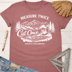 Women's funny woodworking graphic tee shirt for female woodworkers, makers, and DIY builders — Sawdust & Ponytails. Mauve cotton tee with "Measure Twice Cut Once" graphic.