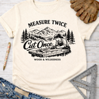 Women's funny woodworking graphic tee shirt for female woodworkers, makers, and DIY builders — Sawdust & Ponytails. Cream t-shirt with "Measure Twice Cut Once" graphic.