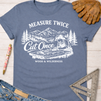 Women's funny woodworking graphic tee shirt for female woodworkers, makers, and DIY builders — Sawdust & Ponytails. Blue cotton tee with "Measure Twice Cut Once" graphic.