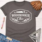 Women's funny woodworking graphic tee shirt for female woodworkers, makers, and DIY builders — Sawdust & Ponytails. Dark gray cotton tee with "Woodworker Chic" graphic.