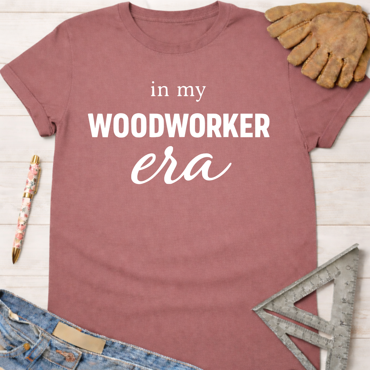 Women's funny woodworking graphic tee shirt for female woodworkers, makers, and DIY builders — Sawdust & Ponytails. Mauve cotton t-shirt with "in my WOODWORKER era" text.
