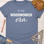 Women's funny woodworking graphic tee shirt for female woodworkers, makers, and DIY builders — Sawdust & Ponytails. Blue cotton t-shirt with "in my WOODWORKER era" text.