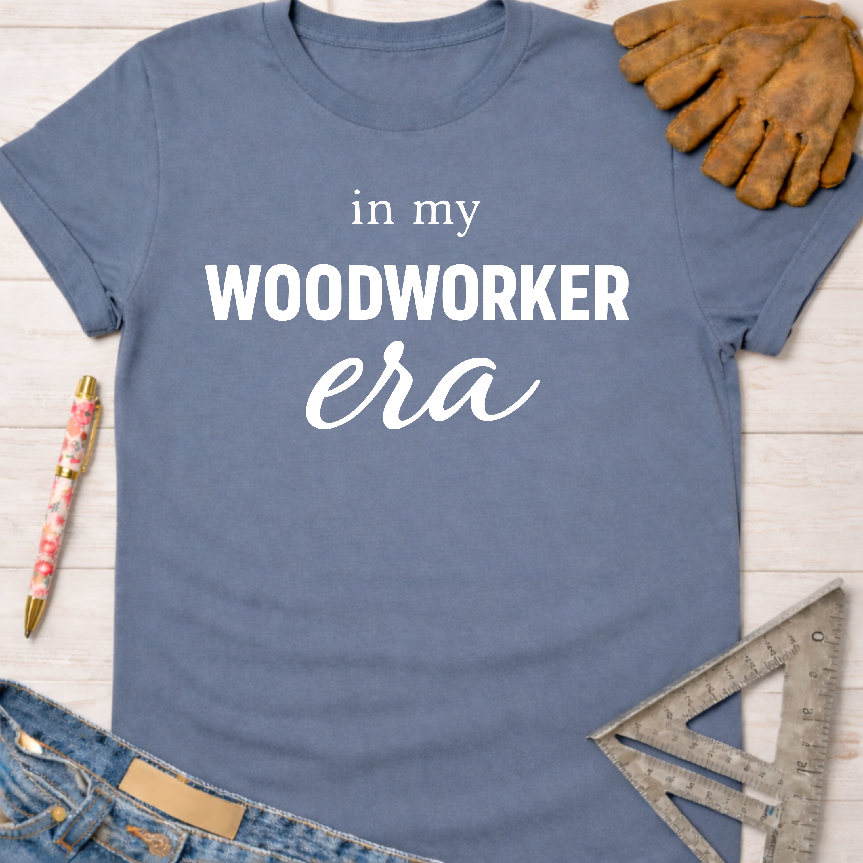 Women's funny woodworking graphic tee shirt for female woodworkers, makers, and DIY builders — Sawdust & Ponytails. Blue cotton t-shirt with "in my WOODWORKER era" text.