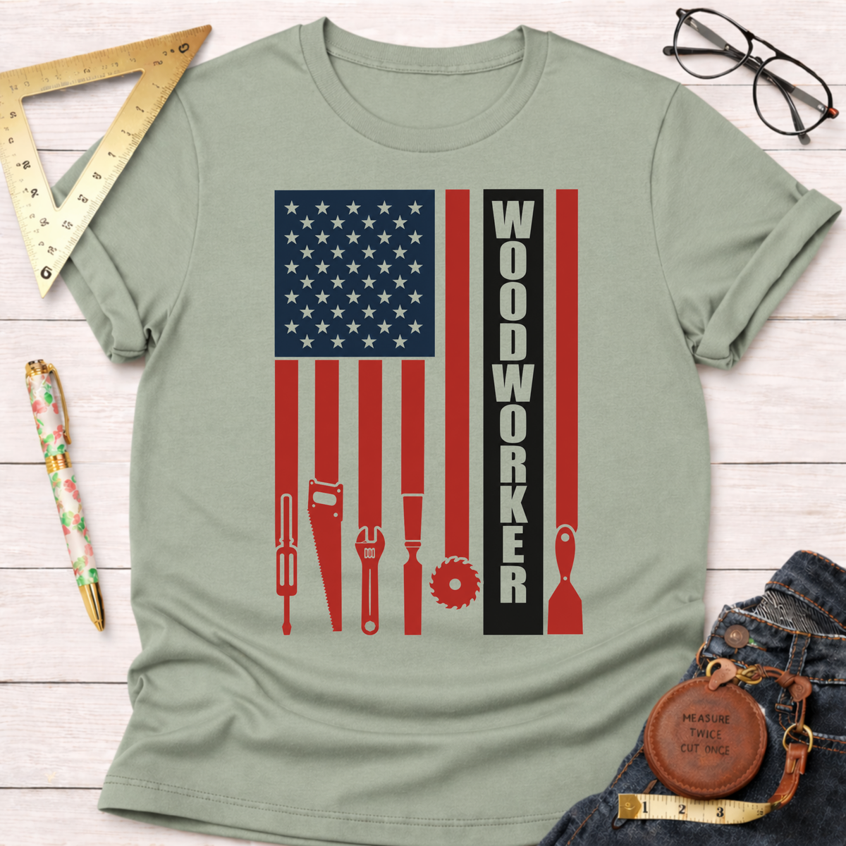 Light green cotton t-shirt with a distressed American flag design featuring woodworking tools and "WOODWORKER" text.