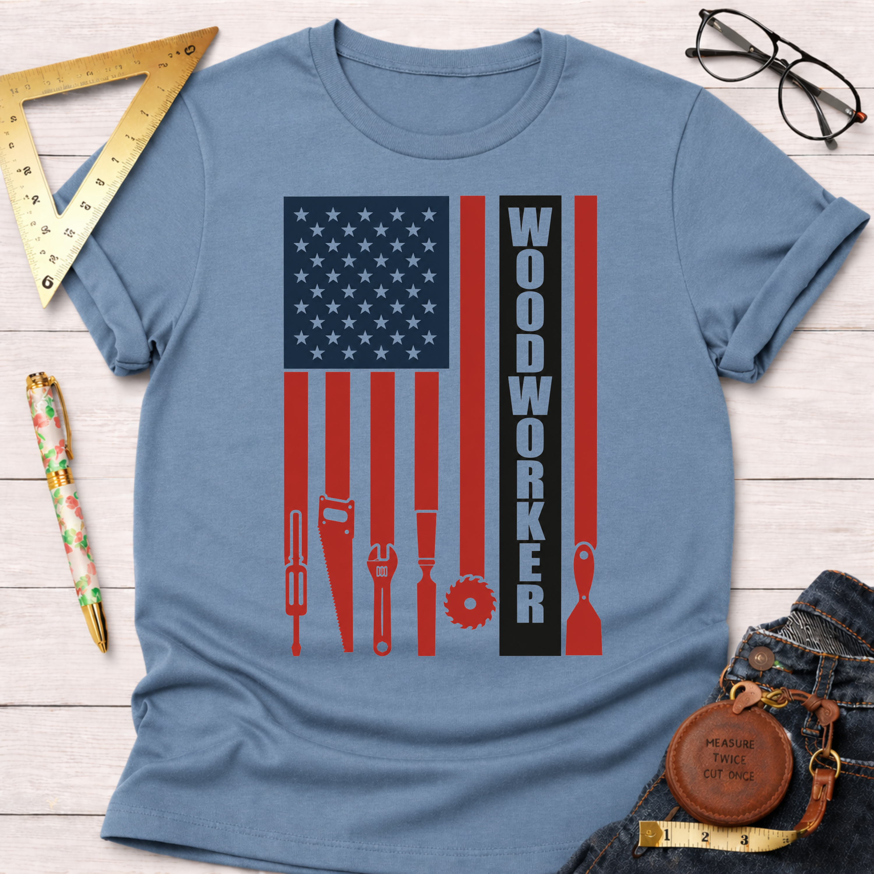 Light blue cotton t-shirt with a distressed American flag design featuring woodworking tools and "WOODWORKER.