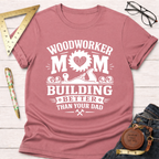 Women's funny woodworking graphic tee shirt for female woodworkers, makers, and DIY builders — Sawdust & Ponytails. Dusty rose short-sleeve t-shirt with "Woodworker Mom Building Better Than Your Dad" graphic.