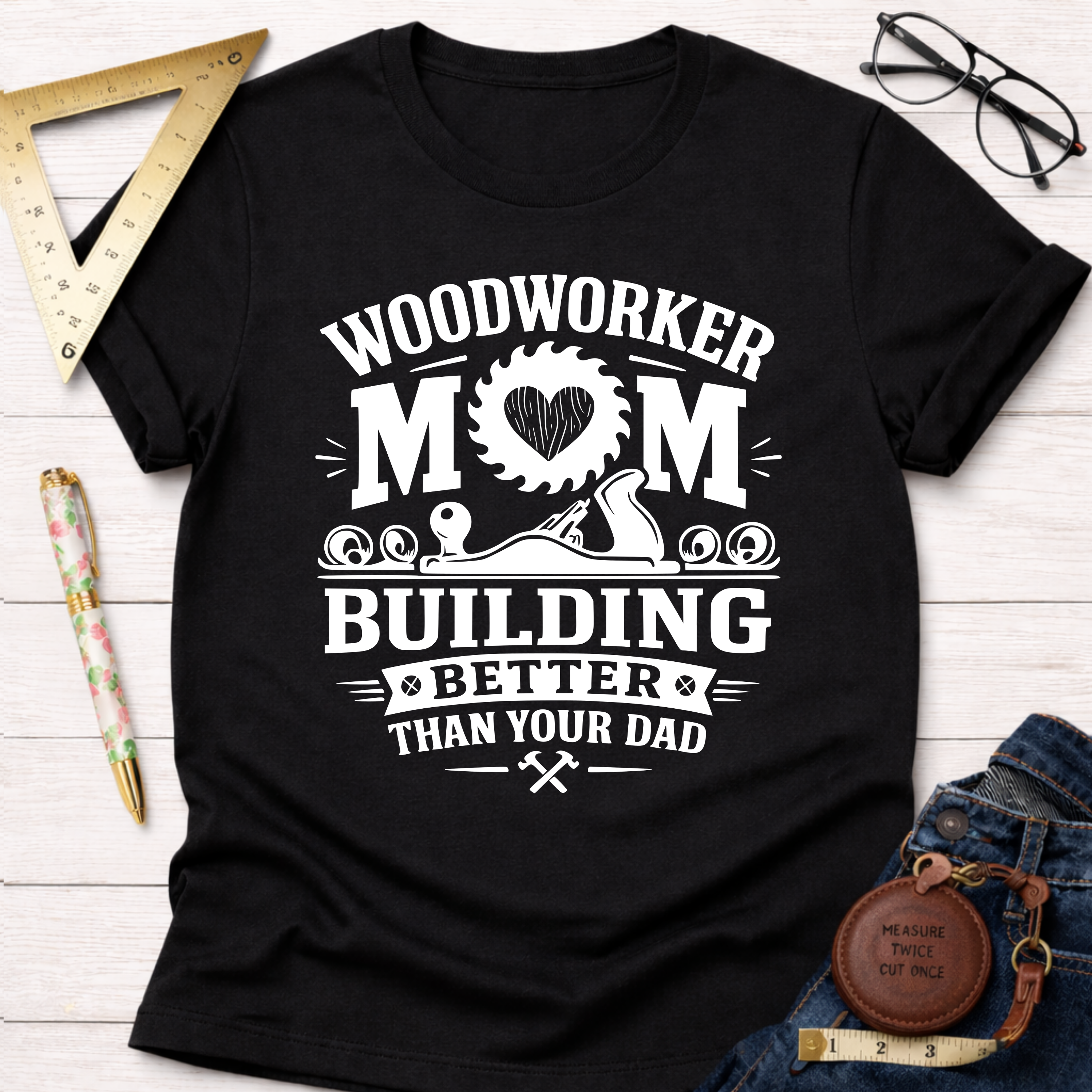 Black cotton "Woodworker Mom Building Better Than Your Dad" graphic tee. Women's funny woodworking graphic tee shirt for female woodworkers, makers, and DIY builders — Sawdust & Ponytails