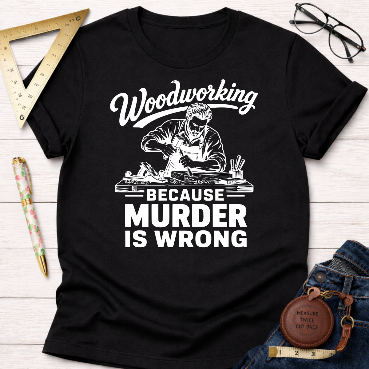 Black cotton t-shirt with "Woodworking Because Murder Is Wrong" graphic and a carpenter working.