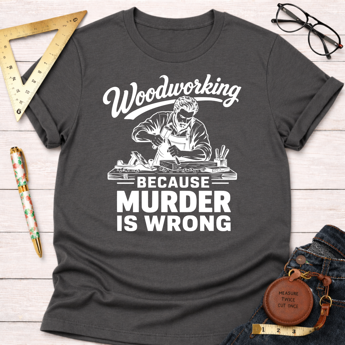 Dark gray t-shirt with "Woodworking Because Murder Is Wrong" graphic featuring a carpenter at work.
