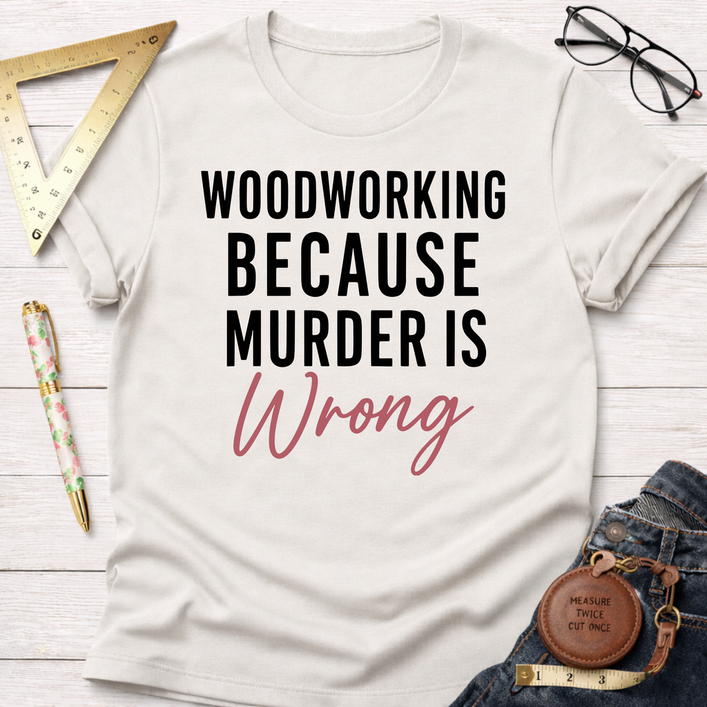 Off-white cotton t-shirt with "WOODWORKING BECAUSE MURDER IS Wrong" in black and pink script.