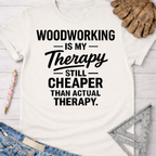 Women's funny woodworking graphic tee shirt for female woodworkers, makers, and DIY builders — Sawdust & Ponytails. White cotton tee with "Woodworking Is My Therapy Still Cheaper Than Actual Therapy" text.