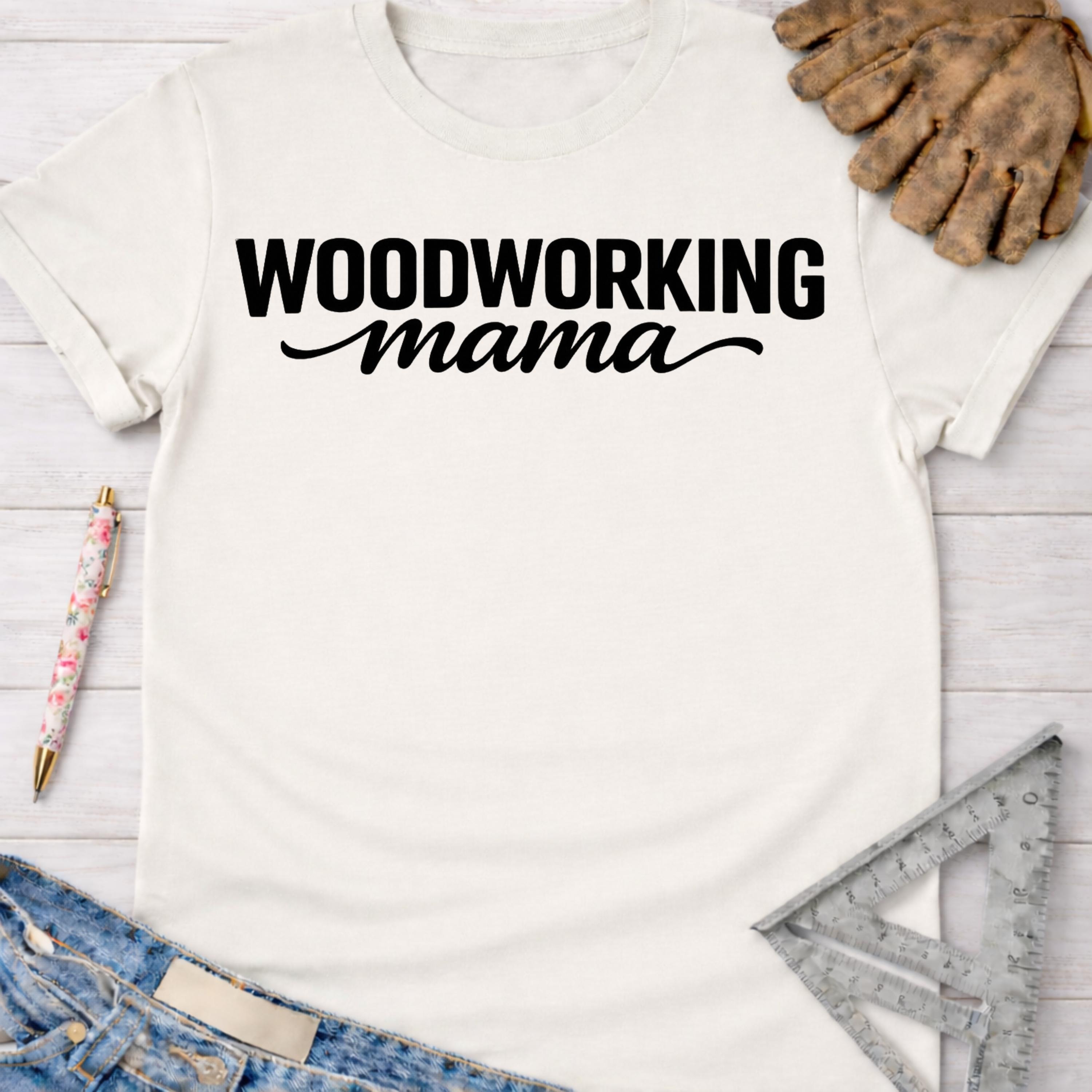 Women's funny woodworking graphic tee shirt for female woodworkers, makers, and DIY builders — Sawdust & Ponytails. White cotton tee with "WOODWORKING mama" in black text.