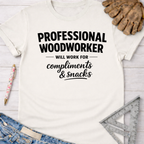 Women's funny woodworking graphic tee shirt for female woodworkers, makers, and DIY builders — Sawdust & Ponytails. White cotton tee with "Professional Woodworker Will Work For Compliments & Snacks" in black text.