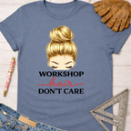 Women's funny woodworking graphic tee shirt for female woodworkers, makers, and DIY builders — Sawdust & Ponytails. Blue cotton tee with "Workshop Hair Don't Care" graphic, featuring a blonde messy bun.