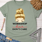 Sage green "Workshop Hair Don't Care" tee with messy bun graphic, women's funny woodworking graphic tee shirt for female woodworkers, makers, and DIY builders — Sawdust & Ponytails.
