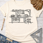 Women's funny woodworking graphic tee shirt for female woodworkers, makers, and DIY builders — Sawdust & Ponytails. Cream heather t-shirt with black line art workshop tools design.