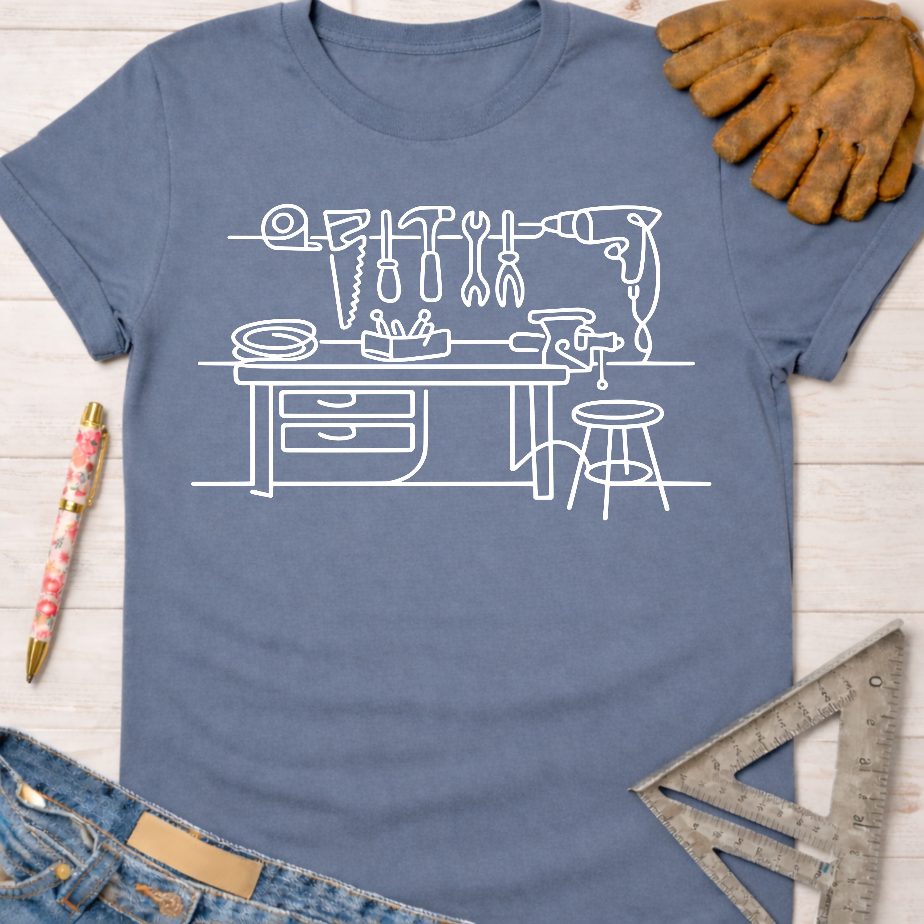 Women's funny woodworking graphic tee shirt for female woodworkers, makers, and DIY builders — Sawdust & Ponytails. Blue cotton tee with white line art workshop tools.