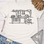 Women's funny woodworking graphic tee shirt for female woodworkers, makers, and DIY builders — Sawdust & Ponytails. Cream cotton tee with black line art workshop tools design.
