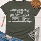 Women's funny woodworking graphic tee shirt for female woodworkers, makers, and DIY builders — Sawdust & Ponytails. Dark gray tee with white line art of a workbench and tools.