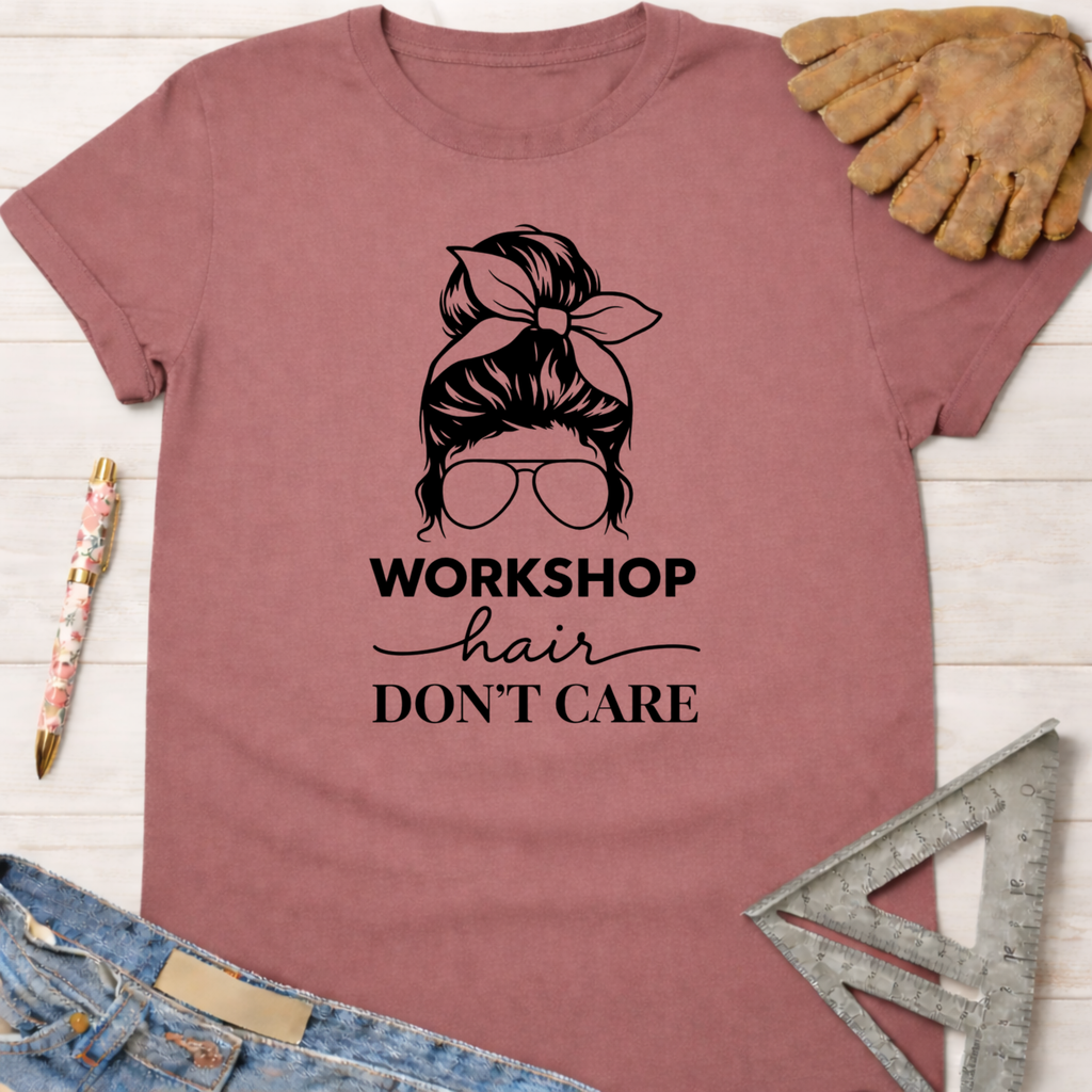 Women's funny woodworking graphic tee shirt for female woodworkers, makers, and DIY builders — Sawdust & Ponytails. Mauve cotton tee with "Workshop Hair Don't Care" messy bun graphic.