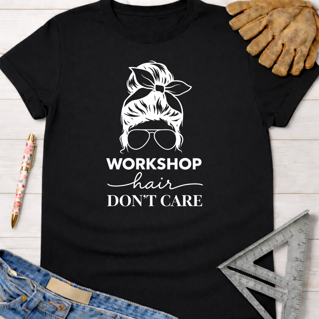 Black cotton tee with "Workshop Hair Don't Care" graphic, messy bun, and sunglasses design. Women's funny woodworking graphic tee shirt for female woodworkers, makers, and DIY builders — Sawdust & Ponytails