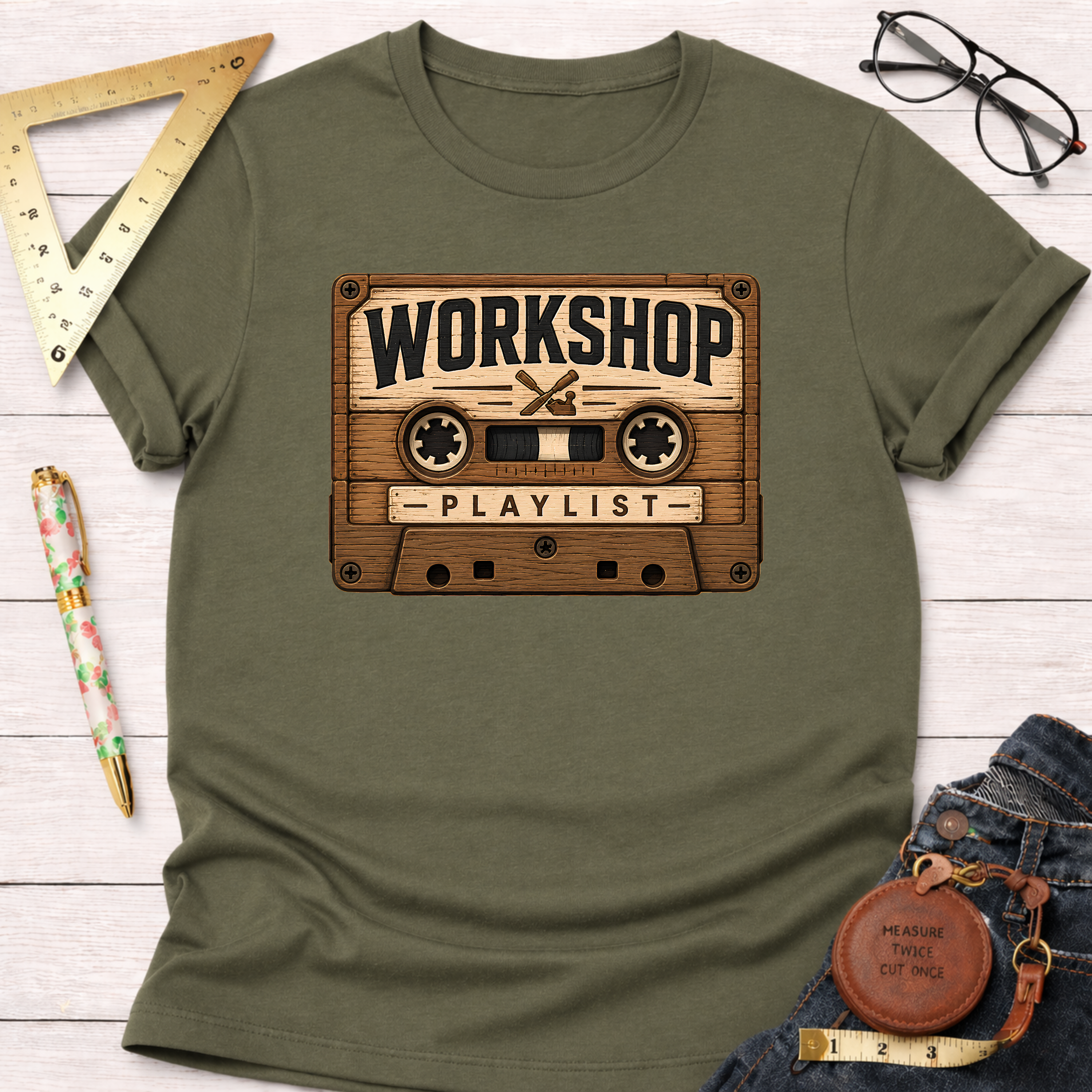 Olive green t-shirt with a vintage wooden cassette tape graphic featuring "WORKSHOP PLAYLIST" text.