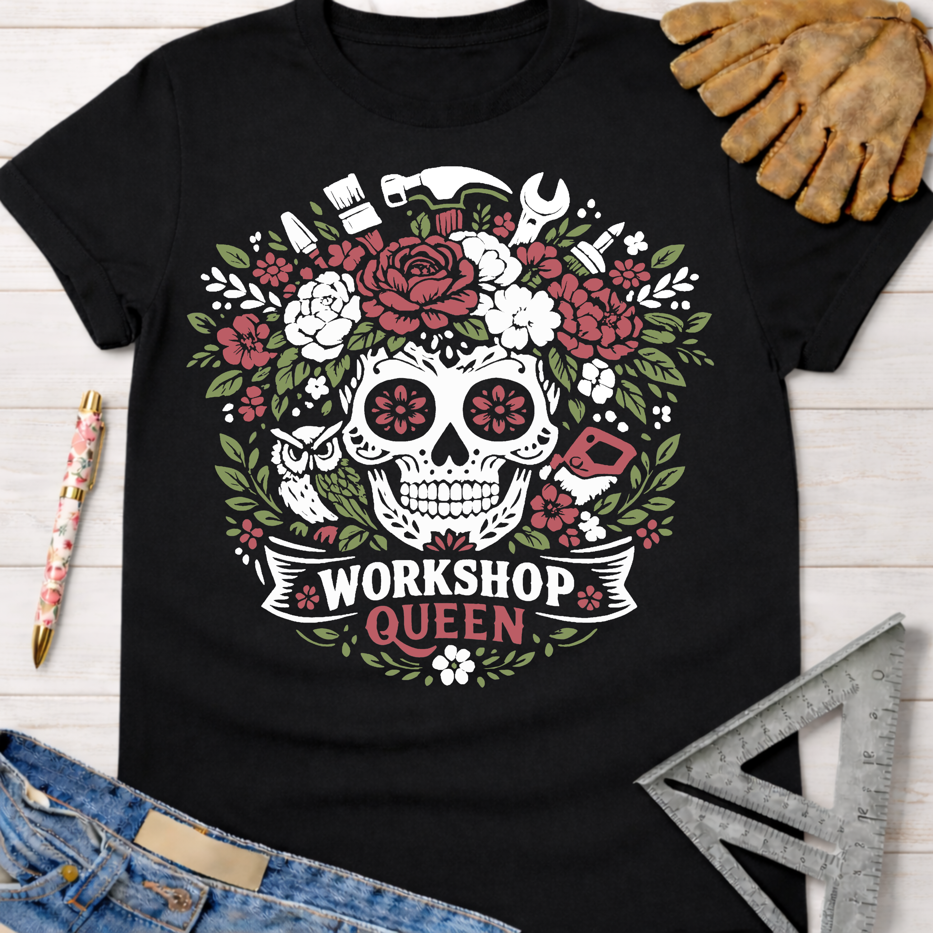Black cotton t-shirt with a floral skull, tools, and "Workshop Queen" graphic. Women's funny woodworking graphic tee shirt for female woodworkers, makers, and DIY builders — Sawdust & Ponytails