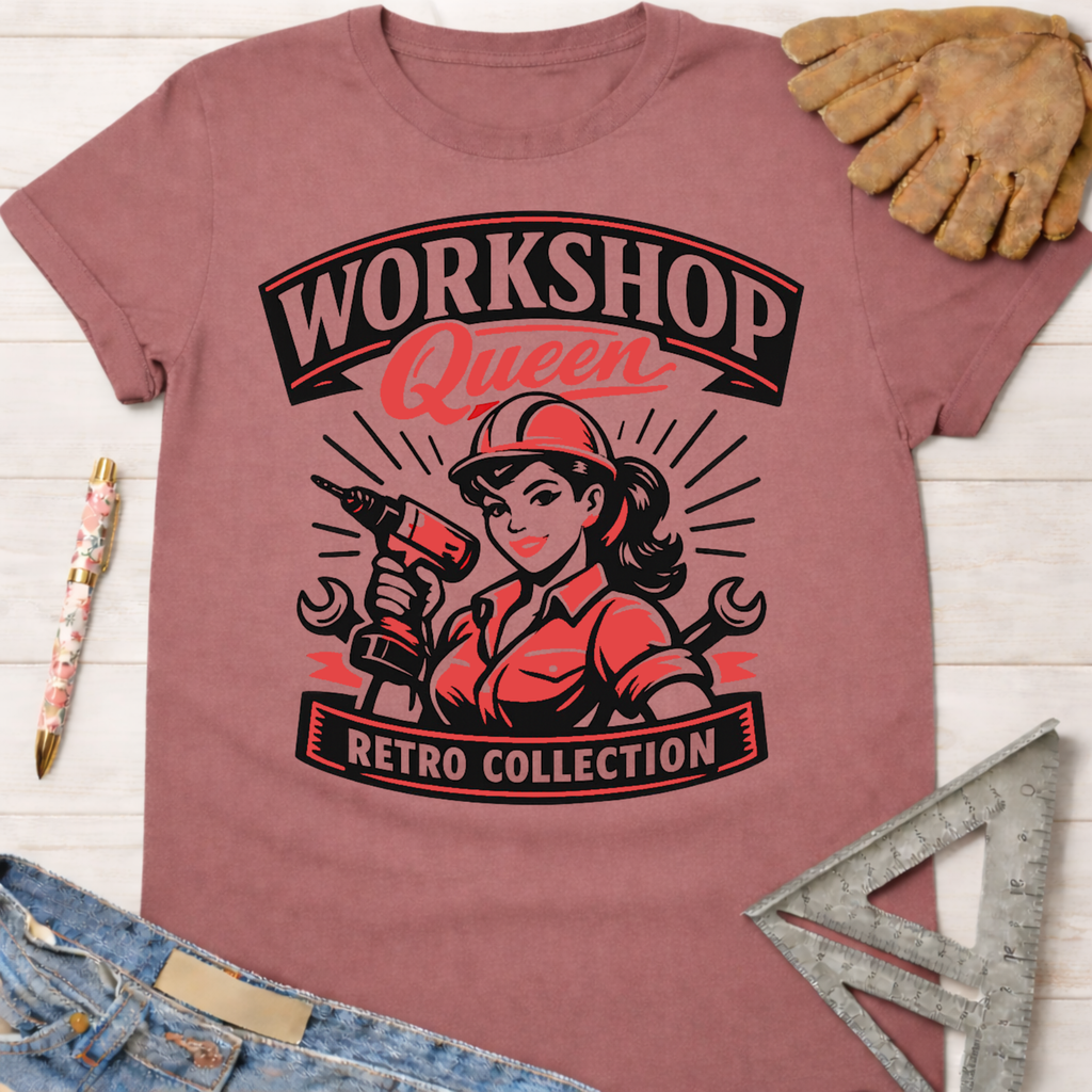 Women's funny woodworking graphic tee shirt for female woodworkers, makers, and DIY builders — Sawdust & Ponytails. Retro pink tee with "Workshop Queen" text and a woman holding a drill.