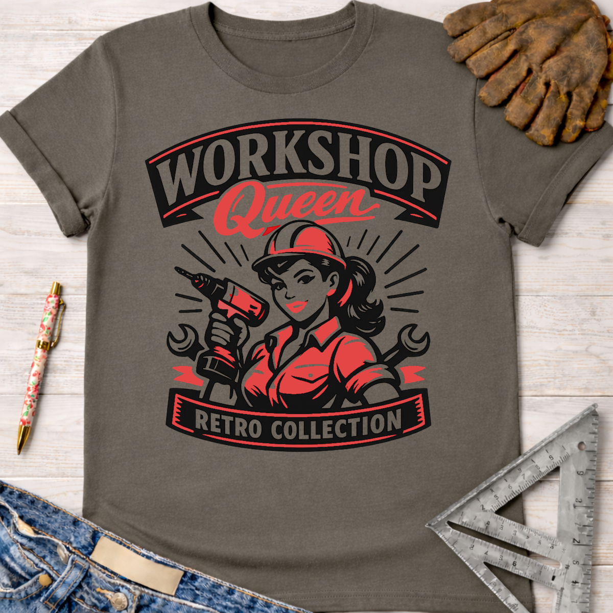 Women's funny woodworking graphic tee shirt for female woodworkers, makers, and DIY builders — Sawdust & Ponytails. Dark gray cotton tee with red and black "Workshop Queen Retro Collection" graphic featuring a woman in a hard hat holding a drill.