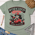 Sage green cotton "Workshop Queen Retro Collection" tee with a female woodworker graphic, paired with jeans and work gloves. Women's funny woodworking graphic tee shirt for female woodworkers, makers, and DIY builders — Sawdust & Ponytails