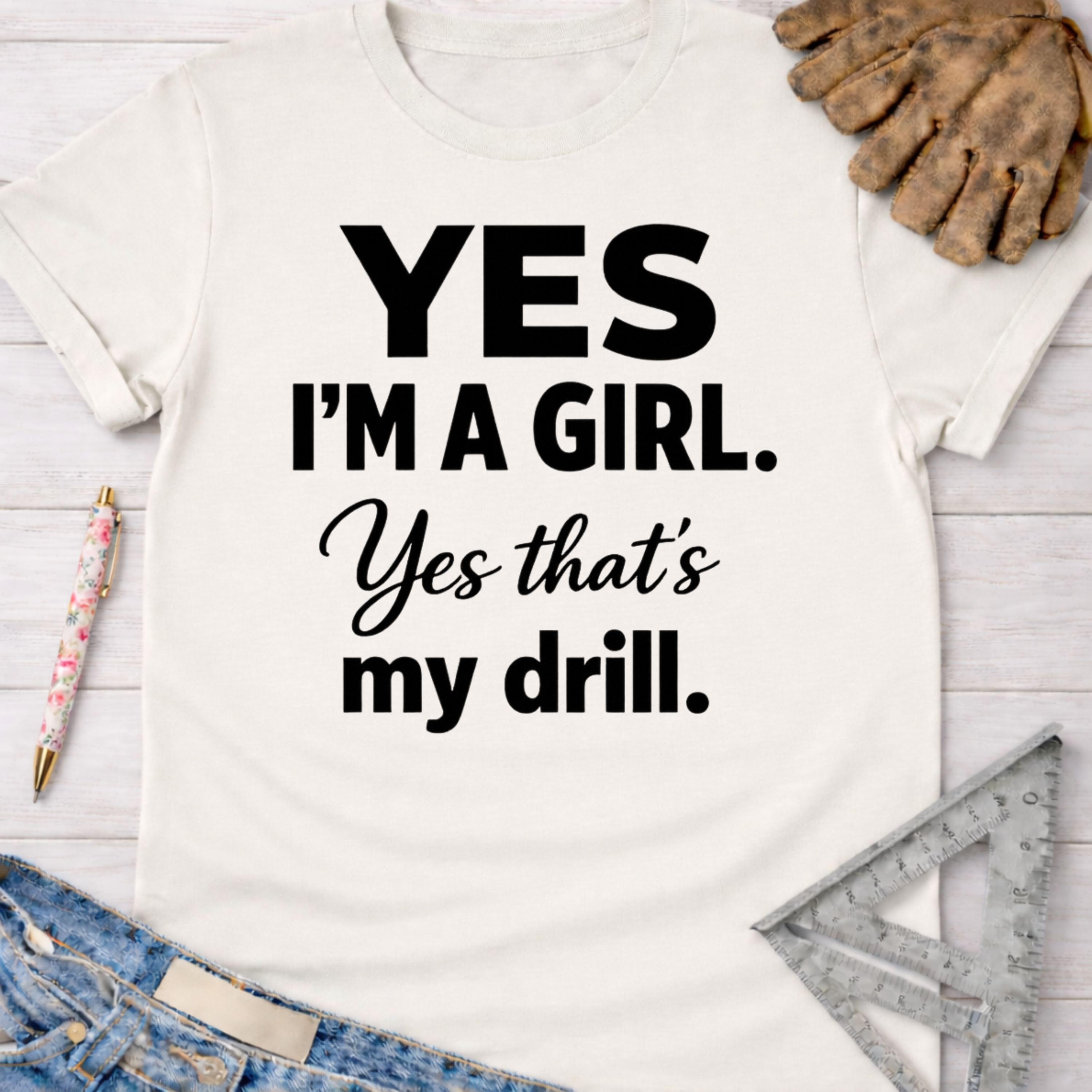 Women's funny woodworking graphic tee shirt for female woodworkers, makers, and DIY builders — Sawdust & Ponytails. White cotton tee with "Yes I'm a Girl. Yes that's my drill." in black text.