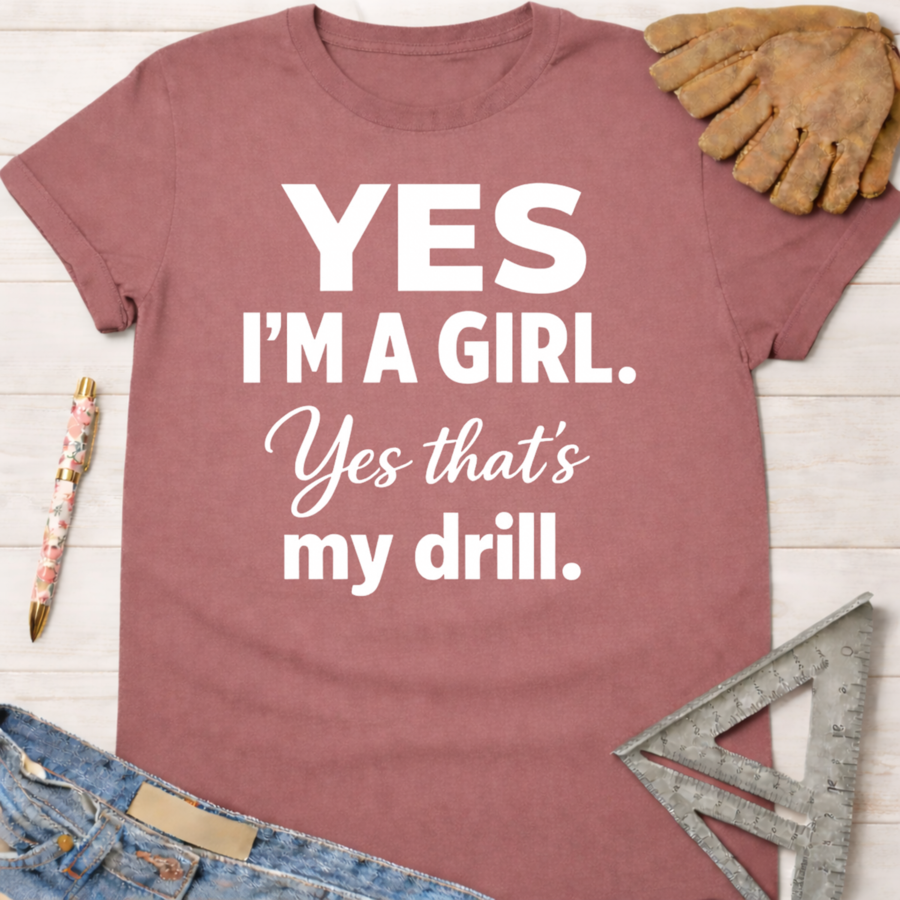 Women's funny woodworking graphic tee shirt for female woodworkers, makers, and DIY builders — Sawdust & Ponytails. Mauve cotton t-shirt with "Yes I'm a Girl. Yes that's my drill." in white text.