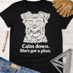 Women's funny woodworking graphic tee shirt for female woodworkers, makers, and DIY builders — Sawdust & Ponytails. Black cotton tee with a white graphic of a dog wearing safety goggles and the text "Calm down. She's got a plan.