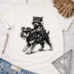 Women's funny woodworking graphic tee shirt for female woodworkers, makers, and DIY builders — Sawdust & Ponytails. White cotton tee with a black graphic of a raccoon riding a schnauzer.