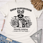 Women's funny woodworking graphic tee shirt for female woodworkers, makers, and DIY builders — Sawdust & Ponytails. White cotton tee with "Shop Supervisor Silently Judging" text and a dog graphic.